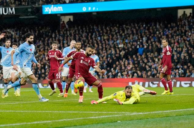 Manchester, England, 9th November 2025. Gianluigi Donnarumma of Manchester City saves at the feet of Mohamed Salah of Liverpool during the Manchester City vs Liverpool Premier League match at the Etihad Stadium, Manchester. Picture credit should read: Andrew Yates Sportimage EDITORIAL USE ONLY. No use with unauthorised audio, video, data, fixture lists, club league logos or live services. Online in-match use limited to 120 images, no video emulation. No use in betting, games or single club league player publications. SPI_077_AY_Man_City_Liverpool SPI-4280-0073