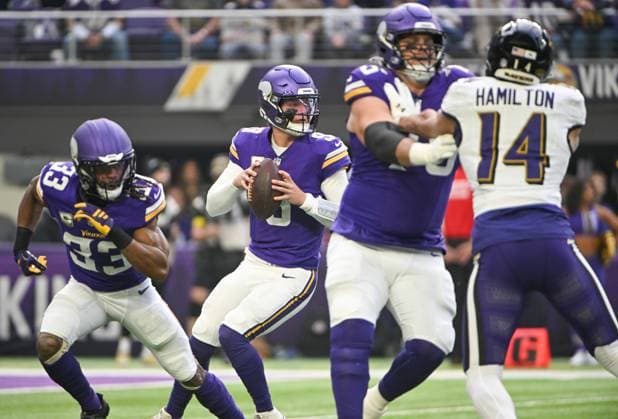 Minnesota Vikings quarterback J.J. McCarthy (C) drops back to throw as offensive tackle Brian O Neill (2R) blocks Baltimore Ravens safety Kyle Hamilton and running back Aaron Jones Sr. (L) and as running back Aaron Jones Sr. (R) looks to block in the first quarter against the Minnesota Vikings at U.S. Bank Stadium in Minneapolis, Minnesota on Sunday, November 9, 2025.  MIN20251109102 CRAIGxLASSIG