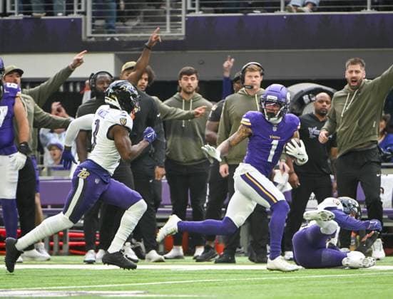 Minnesota Vikings wide receiver Jalen Nailor (R) runs past Baltimore Ravens cornerback Chidobe Awuzie (L) to take a pass 62 yards in the first quarter against the Minnesota Vikings at U.S. Bank Stadium in Minneapolis, Minnesota on Sunday, November 9, 2025.  MIN20251109103 CRAIGxLASSIG