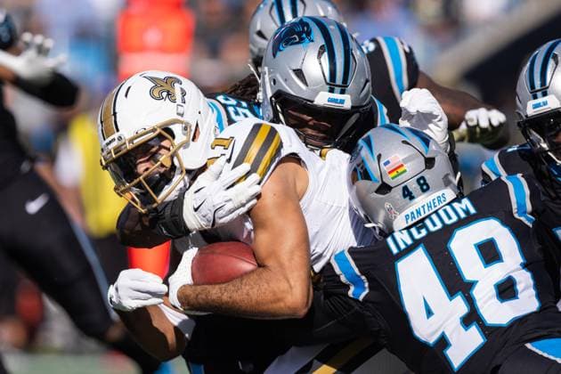 November 9, 2025: New Orleans Saints wide receiver Dante Pettis (11) gets tackled by Carolina Panthers linebacker Maema Njongmeta (55) and linebacker Thomas Incoom (48) in the first half of the NFL, American Football Herren, USA matchup in Charlotte, NC. ( CSM) Charlotte United States - ZUMAc04_ 20251109_zma_c04_044 Copyright: xScottxKinserx