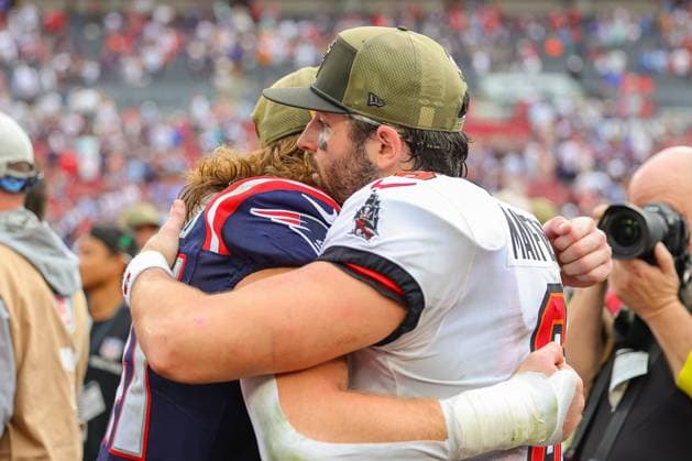 November 9, 2025, Tampa, Florida, USA: Tampa Bay Buccaneers quarterback BAKER MAYFIELD (6) hugs New England Patriots safety BRENDEN SCHOOLER (41) following the National Football League Week 10 game between the New England Patriots and the Tampa Bay Buccaneers, New England Patriots win 28-23, at Raymond James Stadium. Tampa USA - ZUMAs335 20251109_znp_s335_007 Copyright: xMatthewxSmithx
