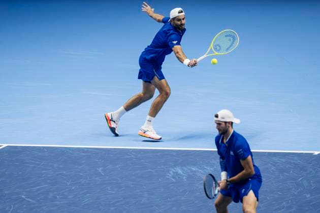 Nitto ATP, Tennis Herren Finals 2025 - Day One Simone Bolelli (top) of Italy plays a backhand next to Andrea Vavassori of Italy during the round robin doubles match against Julian Cash and Lloyd Glasspool of Great Britain during day one of the Nitto ATP Finals 2025. Simone Bolelli and Andrea Vavassori won 7-5, 6-3. Turin Italy Copyright: xNicolòxCampox