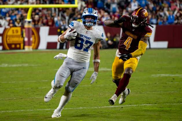 Detroit Lions Sam LaPorta (87) runs to convert a third down as Washington Commanders linebacker Frankie Luvu (4) advances during the second quarter of a game at Northwest Stadium in Landover, Maryland on Sunday, November 9, 2025. The Lions beat the Commanders 44-22.  WAP20251109353 BONNIExCASH