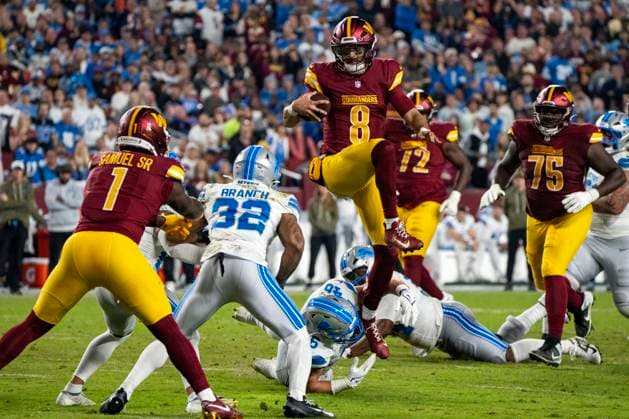 Washington Commanders quarterback Marcus Mariota (8) jumps over Detroit Lions linebacker Jack Campbell (46) in an attempt to convert a third down during the second quarter of a game at Northwest Stadium in Landover, Maryland on Sunday, November 9, 2025. The Lions beat the Commanders 44-22.  WAP20251109335 BONNIExCASH