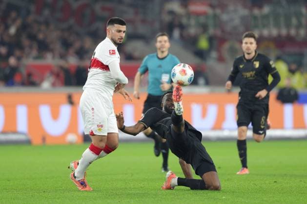 Stuttgart , Bundesliga Football VfB Stuttgart vs FC Augsburg , v l Deniz Undav VfB Chrislain Matsima Augsburg In accordance with the regulations of the DFL German Football League, it is prohibited to use or have used photographs taken in the stadium and or of the match in the form of sequential images and or video-like photo series