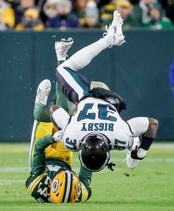 Philadelphia Eagles running back Tank Bigsby flips over Green Bay Packers cornerback Carrington Valentine in the first half of the NFL, American Football Herren, USA game between the Philadelphia Eagles and the Green Bay Packers at Lambeau Field in Green Bay, Wisconsin on Monday, November 10, 2025.  MIL20251110214 TANNENxMAURY