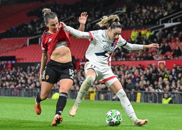Manchester, England, 12th November 2025. Olga Carmona of Paris Saint-Germain holds off Julia Zigiotti Olme of Manchester United, ManU during the Manchester United Women vs Paris St Germain Women UEFA Womens Champions League match at Old Trafford, Manchester. Picture credit should read: Cody Froggatt Sportimage EDITORIAL USE ONLY. No use with unauthorised audio, video, data, fixture lists, club league logos or live services. Online in-match use limited to 120 images, no video emulation. No use in betting, games or single club league player publications. SPI_043_CF_MANCHESTER_UTD_WOMEN_V_PARIS_ST_GERMAIN_WOMEN SPI-4282-0043