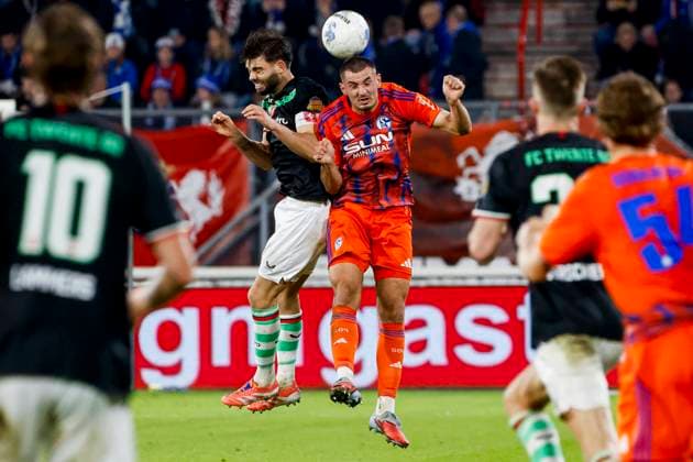 Bojan Potnar of Schalke 04 and Robin Propper of FC Twente compete for the headed ball FC Twente v FC Schalke 04, 60th Anniversary Game, FC Twente v Schalke 04, De Grolsch Veste Stadium, November 13, 2025, Enschede, Netherlands.