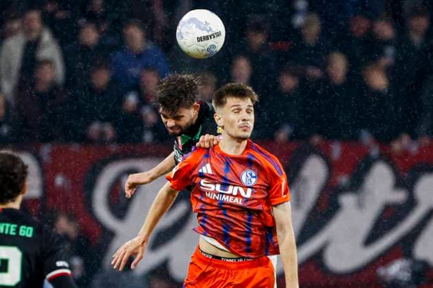 Robin Propper of FC Twente and Malik Tubic of Schalke 04 compete for the headed ball FC Twente v FC Schalke 04, 60th Anniversary Game, FC Twente v Schalke 04, De Grolsch Veste Stadium, November 13, 2025, Enschede, Netherlands.