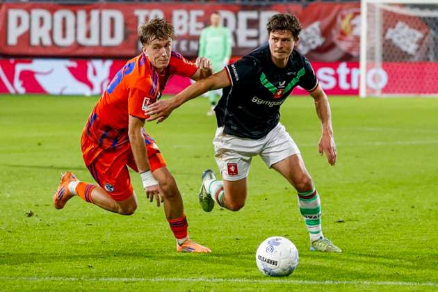 Bas Kuipers of FC Twente and Paul Popperl of Schalke 04 battle for the ball FC Twente v FC Schalke 04, 60th Anniversary Game, FC Twente v Schalke 04, De Grolsch Veste Stadium, November 13, 2025, Enschede, Netherlands.