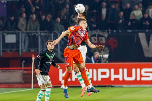 Robin Propper of FC Twente and Malik Tubic of Schalke 04 compete for the headed ball FC Twente v FC Schalke 04, 60th Anniversary Game, FC Twente v Schalke 04, De Grolsch Veste Stadium, November 13, 2025, Enschede, Netherlands.