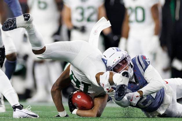 New England Patriots cornerback Charles Woods, right, tackles New York Jets wide receiver Isaiah Williams, left, during the second half at Gillette Stadium in Foxborough, Massachusetts on Thursday, November 13, 2025.  BOP20251113027 CJxGUNTHER
