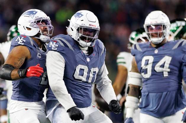 New England Patriots defensive tackle Christian Barmore, center, celebrates a sack with New England Patriots linebacker Harold Landry III, left, and New England Patriots defensive tackle Cory Durden, right, during the second half against the New York Jets at Gillette Stadium in Foxborough, Massachusetts on Thursday, November 13, 2025.  BOP20251113029 CJxGUNTHER