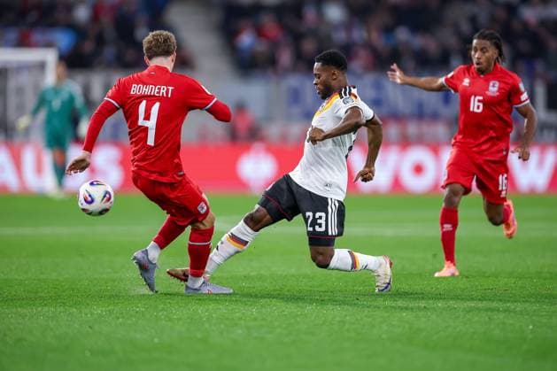 14 11 2025, Football, International match, World Cup Qualification Europe, Germany Luxembourg, Stade de Luxembourg Croix de Gasperich, Luxembourg , Matchday 9, Season 2025 2026 Florian Bohnert LUX 04 and Adulai Djabi Embalo LUX 03 in a duel against Ridle Baku GER 23 Regulations prohibit any use of photographs as image sequences and or quasi video Luxembourg