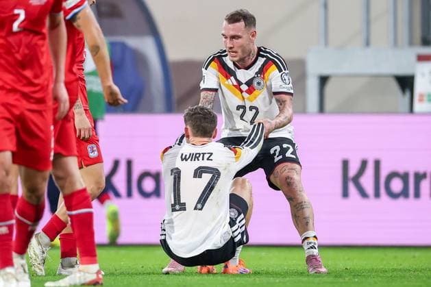 14 11 2025, Football, International match, World Cup Qualification Europe, Germany Luxembourg, Stade de Luxembourg Croix de Gasperich, Luxembourg , 9 Matchday, Season 2025 2026 David Raum GER 22 helps Florian Wirtz GER 17 on his feet Regulations prohibit any use of photographs as image sequences and or quasi video Luxembourg
