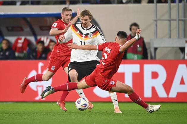 Nick WOLTEMADE GER vs Seid KORAC LUX action, duel, Luxembourg LUX Germany GER football international, World Cup Qualification Europe Group A, matchday 9, matchday9, on 14 1 2025, Stade de Luxembourg, Luxembourg, Â