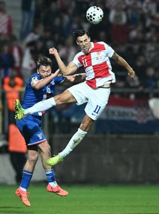 Croatia v Faroe Islands - FIFA World Cup, WM, Weltmeisterschaft, Fussball 2026 Qualifier RIJEKA, CROATIA - NOVEMBER 14: Gunnar Vatnhamar of Faroe Islands and Petar Musa of Croatia jumps for the ball during the FIFA World Cup 2026 qualifier match between Croatia and Faroe Islands at HNK Rijeka Stadium on November 14, 2025 in Rijeka, Croatia.  MarkoxLukunic PIXSELL