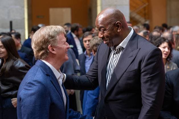 November 14, 2025, Madrid, Spain: NFL, American Football Herren, USA Commissioner Roger Goodle and former American basketball player Earvin Magic Johnson greet each other during the official welcome ceremony for the National Football League NFL. The Community of Madrid received representatives of the National Football League NFL, the American football league, at the Royal Post Office, the seat of the regional government, on the occasion of the game that will pit the Miami Dolphins against the Washington Commanders this Sunday at the Santiago BernabÃ u stadium in the Spanish capital. Madrid Spain - ZUMAs197 20251114_aaa_s197_122 Copyright: xDavidxCanalesx Madrid Spain - ZUMA0840 20251114_aaa_s197_122 Copyright: xIMAGO DavidxCanalesx
