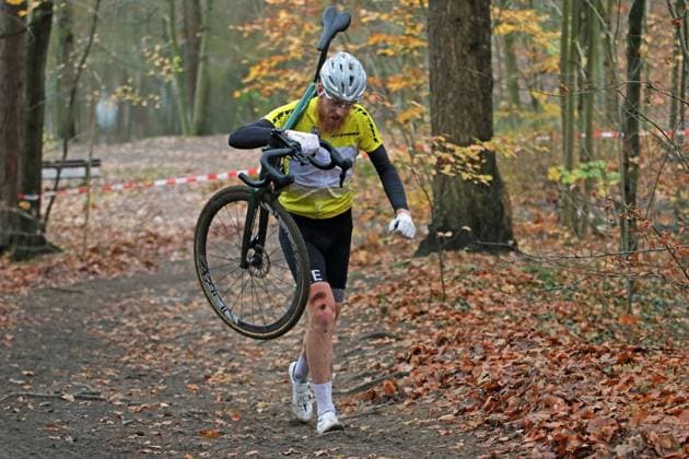 Stevens Cyclo Cross Cup elite field, masters and juniors on the Am Butterberg course in Elmshorn Overall leader Frederik von Hartwig TS Klinkrade has to carry his bike to the finish after sustaining damage on the last lap