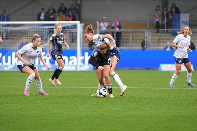 C fights for the ball against an opponent, while D and B defend attentively and A watches the action DFB Womens Cup TSG Hoffenheim v Eintracht Frankfurt, at the Dietmar Hopp Stadium in Hoffenheim Players fight for the ball Copyright: xspeedshotx