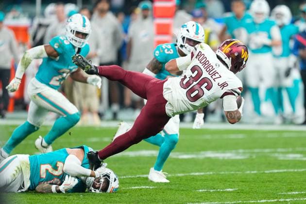 November 16, 2025, Madrid, Madrid, Spain: Bradley Chubb of the Miami Dolphins and Chris Rodriguez Jr. of the Washington Commanders in action during the National Football League NFL, American Football Herren, USA 2025 Madrid Game, match played between Miami Dolphins and Washington Commanders at Bernabeu stadium on November 16, 2025, in Madrid, Spain. Madrid Spain - ZUMAa181 20251116_zaa_a181_086 Copyright: xOscarxJ.xBarrosox