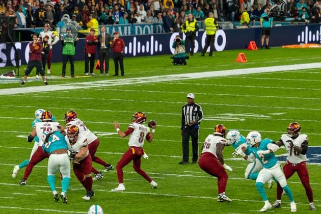The O-Line gives Marcus Mariota (Washington Commanders, 8) time to thorw the ball, Miami Dolphins vs Washington Commanders, American Football, National Football League, Season 2025, Week 11, 16.11.2025, Madrid Estadio Bernabeu Spain Copyright: xFootxBowl ThomasxMummertx