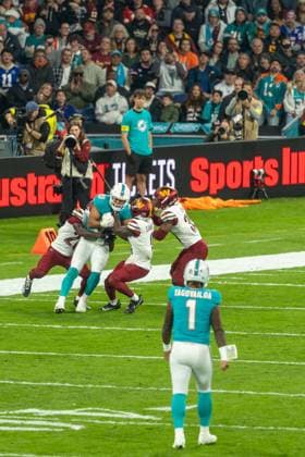 Julian Hill (Miami Dolphins, 89) witth the ball got brought down by 3, Miami Dolphins vs Washington Commanders, American Football, National Football League, Season 2025, Week 11, 16.11.2025, Madrid Estadio Bernabeu Spain Copyright: xFootxBowl ThomasxMummertx