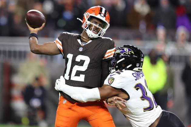 Cleveland Browns Shedeur Sanders (12) throws as he is hit by Baltimore Ravens Trenton Simpson (32) during the fourth quarter at Huntington Bank Field in Cleveland, Ohio on Sunday November 16, 2025.  CLE20251116134 AARONxJOSEFCZYK