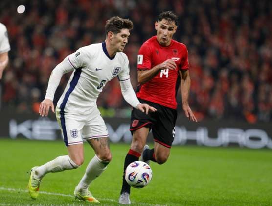 Group K European qualification football match between Albania and England in Tirana, Albania. - 15 November 2025. Albania s Qazim Laci (R) fights for the ball with England s John Stones (L) during the FIFA World Cup, WM, Weltmeisterschaft, Fussball 2026 European qualification football match between Albania and England at the Air Albania stadium in Tirana, on November 16, 2025. TIRANA ALBANIA Copyright: xMALTONxDIBRAx