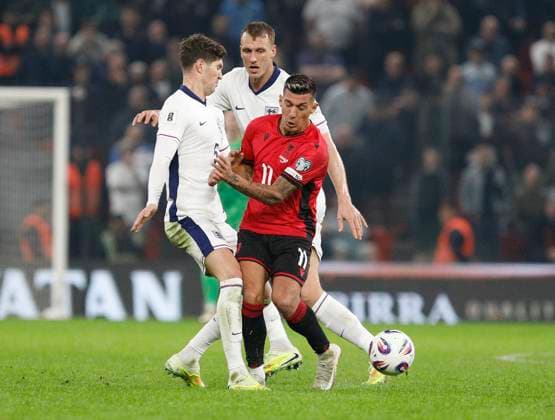 Group K European qualification football match between Albania and England in Tirana, Albania. - 15 November 2025. Albania s Myrto Uzuni (R) fights for the ball with England s John Stones (L) during the FIFA World Cup, WM, Weltmeisterschaft, Fussball 2026 European qualification football match between Albania and England at the Air Albania stadium in Tirana, on November 16, 2025. TIRANA ALBANIA Copyright: xMALTONxDIBRAx