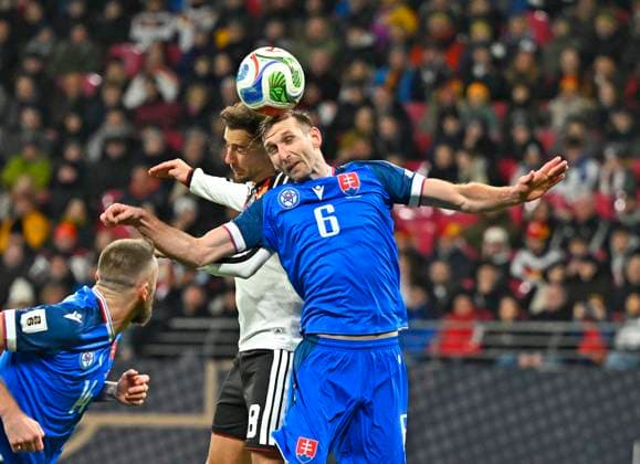 17 11 2025, Football World Cup Qualification Europe 2025 26, Matchday 10, Germany Slovakia, at Red Bull Arena Leipzig Germany v l Leon Goretzka Germany v Norbert Gyömber Slovakia