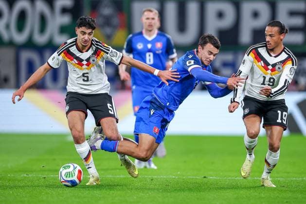 17 11 2025, Football, International match, World Cup Qualification Europe, Germany Slovakia, Red Bull Arena Leipzig , Matchday 10, Season 2025 2026 Aleksandar Pavlovic GER 05 in duel against David Strelec SLK 15 next to Leroy Sane GER 19 Regulations prohibit any use of photographs as image sequences and or quasi video Saxony Germany