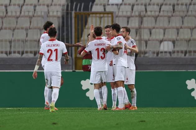 Robert Lewandowski (back) of Poland is congratulated by team mates after scoring the 0-1 goal during the FIFA World Cup, WM, Weltmeisterschaft, Fussball 26 UEFA European Qualifier Group G match between Malta and Poland, at the National Stadium, in Ta Qali, Malta, 17 November 2025. FIFA World Cup 26 Qualifiers - Malta vs Poland