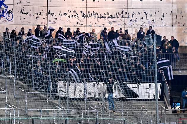 SV Wacker Burghausen fans waving flags and creating atmosphere, fans, audience, spectators, mood, atmosphere, stadium, 18 11 2025, Unterhaching Germany , football, BFV Verbandspokal, quarter-final, SpVgg Unterhaching SV Wacker Burghausen xslx