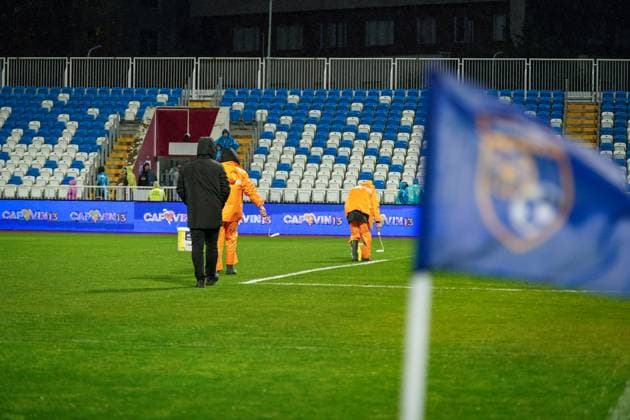 Football World Cup Qualification 2025 26, 10 matchday Kosovo vs Switzerland Fadil Vokrri Stadium Pristina Pristina, Kosovo, Europe pitch workers in heavy rain, manual line correction, bucket paint, rain protection orange, wet pitch, match preparation, infrastructure, groundskeeping, UEFA Quali, weather situation, safety, matchday, media relevance severe weather, pitch maintenance, soccer organization Pristina Kosovo Copyright: xJOERANxSTEINSIEKx