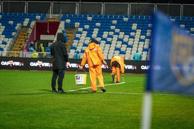 Football World Cup Qualification 2025 26, 10 matchday Kosovo vs Switzerland Fadil Vokrri Stadium Pristina Pristina, Kosovo, Europe pitch workers in heavy rain, manual line correction, bucket paint, rain protection orange, wet pitch, match preparation, infrastructure, groundskeeping, UEFA Quali, weather situation, safety, matchday, media relevance severe weather, pitch maintenance, soccer organization Pristina Kosovo Copyright: xJOERANxSTEINSIEKx