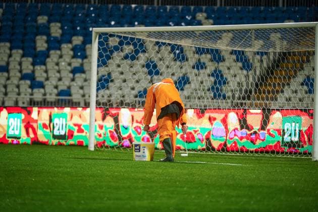 Football World Cup Qualification 2025 26, 10 matchday Kosovo vs Switzerland Fadil Vokrri Stadium Pristina Pristina, Kosovo, Europe pitch workers in heavy rain, manual line correction, bucket paint, rain protection orange, wet pitch, match preparation, infrastructure, groundskeeping, UEFA Quali, weather situation, safety, matchday, media relevance severe weather, pitch maintenance, soccer organization Pristina Kosovo Copyright: xJOERANxSTEINSIEKx