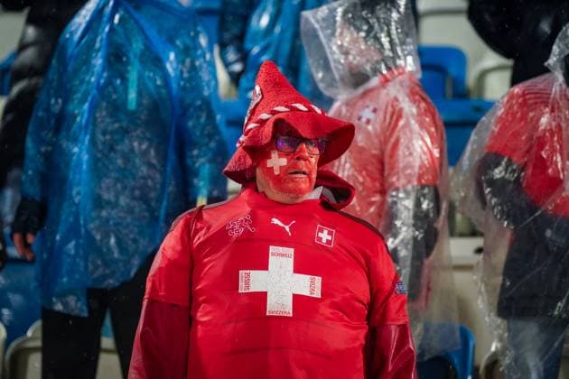 Football World Cup Qualification 2025 26, 10 Matchday Kosovo vs Switzerland Fadil Vokrri Stadium Pristina Pristina, Kosovo, Europe Swiss fans in heavy rain, dressed in red, supporter with painted face, scarves Switzerland Suisse SvizzerA Svizra, ponchos, fan block, emotions, away support, atmosphere, wetness, weather situation, qualification, soccer culture, media relevance fan behavior, weather, security, Matchday Pristina Kosovo Copyright: xJOERANxSTEINSIEKx