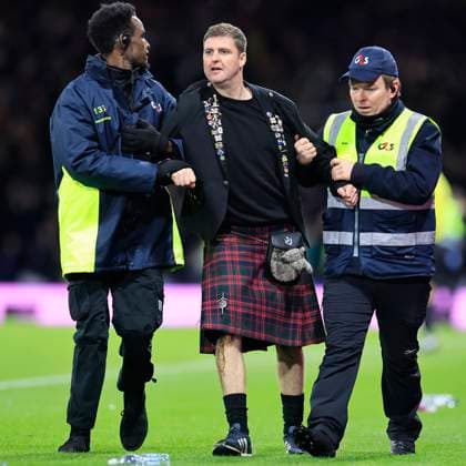 Scotland v Denmark 2026 FIFA World Cup, WM, Weltmeisterschaft, Fussball Qualifiers A Scotland supporter who ran onto the pitch us escorted by security during the 2026 FIFA World Cup Qualifiers Group C match at Hampden Park, Glasgow UK Newspapers OUT Copyright: xFredxPalmerx FIL-22515-0152