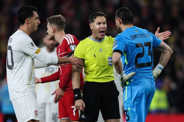Cardiff, Wales, 18th November 2025. Referee Danny Makkelie talks to Stole Dimitrievski of North Macedonia during the Wales vs North Macedonia UEFA European Championship, EM, Europameisterschaft Qualifying match at the Cardiff City Stadium, Cardiff. Picture credit should read: Gareth Evans Sportimage EDITORIAL USE ONLY. No use with unauthorised audio, video, data, fixture lists, club league logos or live services. Online in-match use limited to 120 images, no video emulation. No use in betting, games or single club league player publications. SPI_098_GE_WAL_MKD SPI-4291-0100