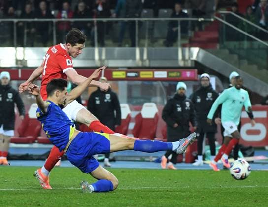 Sport Bilder des Tages (251119) -- VIENNA, Nov. 19, 2025 -- Michael Gregoritsch (top) of Austria shoots during the 2026 World Cup European Qualifiers match between Austria VS Bosnia and Herzegovina in Vienna, Austria, Nov. 18, 2025. ) (SP)AUSTRIA-VIENNA-FOOTBALL-2026 WORLD CUP EUROPEAN QUALIFIERS-AUSTRIA VS BOSNIA AND HERZEGOVINA HexCanling 