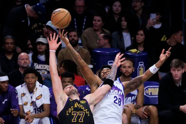 November 18, 2025, Los Angeles, California, USA: Luka Doncic 77 of the Los Angeles Lakers and Brice Sensabaugh 28 of the Utah Jazz reach for the rebound during their regular season NBA, Basketball Herren, USA game on Tuesday November 18, 2025 at Crypto.com Arena in Los Angeles, California. Lakers defeat Jazz, 140-127. ARIANA RUIZ PI Los Angeles USA - ZUMAp124 20251118_zaa_p124_092 Copyright: xArianaxRuizx