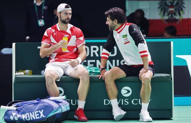 TENNIS - Davis Cup Final 8 BOLOGNA,ITALY,19.NOV.25 - TENNIS - ITF Davis Cup, Final 8, Italy vs Austria. Image shows Jurij Rodionov and captain Juergen Melzer (AUT).  GEPAxpictures xMatthiasxHauer
