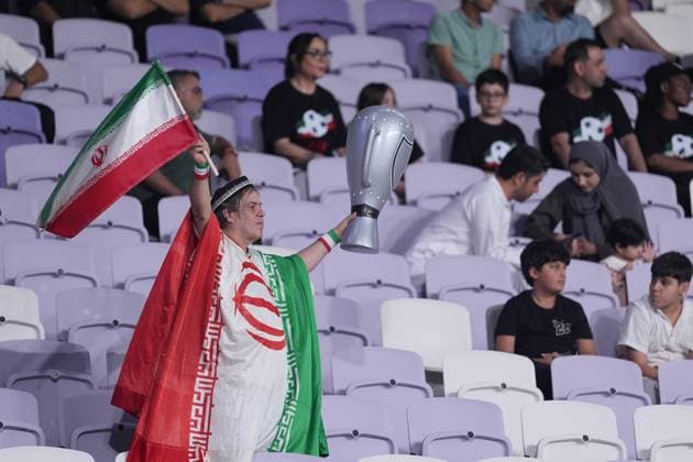 18 November 2025 : Fan of IRAN football national team, Nationalteam with flags and trophy during the FIFA football friendly international soccer match between Uzbekistan National team and Iran national team at Al Maktoum Stadium stadium, Dubai city.UAE Uzbekistan National team v Iran national team, pre World Cup 2026 Copyright: xSebastianxFrejx