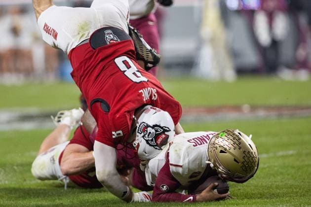 November 21, 2025: NC State Wolfpack wide receiver Keenan Jackson (8) tackles Florida State Seminoles quarterback Tommy Castellanos (1) during the first half of the NCAA, College League, USA football match up at Carter-Finley Stadium in Raleigh, NC. ( CSM) Raleigh United States - ZUMAc04_ 20251121_zma_c04_250 Copyright: xScottxKinserx