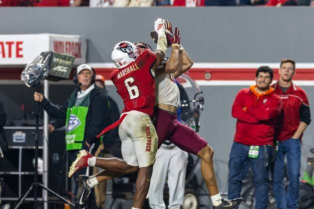 November 21, 2025, Raleigh, North Carolina, USA: Florida State Seminoles wide receiver DUCE ROBINSON (0) catches a deep pass over NC State Wolfpack defensive back DEVON MARSHALL (6) during the second half of the NCAA, College League, USA football game between the Florida State Seminoles and the NC State Wolfpack on November 21st, 2025 at Carter-Finley Stadium in Raleigh, NC. Raleigh USA - ZUMAa220 20251121_znp_a220_078 Copyright: xIsraelxAntax
