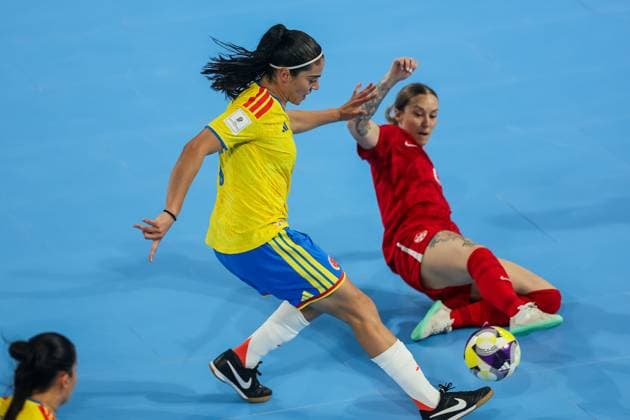 (251122) -- PASIG CITY, Nov. 22, 2025 -- Merlin Salcedo (L) of Colombia vies against Erika Pion (R) of Canada during the match between Colombia and Canada at the FIFA Futsal Women s World Cup 2025 in Pasig City, the Philippines, Nov. 22, 2025. ) (SP)PHILIPPINES-PASIG CITY-FUTSAL-WOMEN S WORLD CUP 2025-COLOMBIA VS CANADA RouellexUmali 