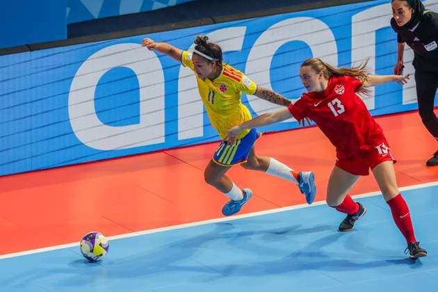 (251122) -- PASIG CITY, Nov. 22, 2025 -- Dayana Rivera (L) of Colombia competes against Katerine Delev (R) of Canada during the match between Colombia and Canada at the FIFA Futsal Women s World Cup 2025 in Pasig City, the Philippines, Nov. 22, 2025. ) (SP)PHILIPPINES-PASIG CITY-FUTSAL-WOMEN S WORLD CUP 2025-COLOMBIA VS CANADA RouellexUmali 