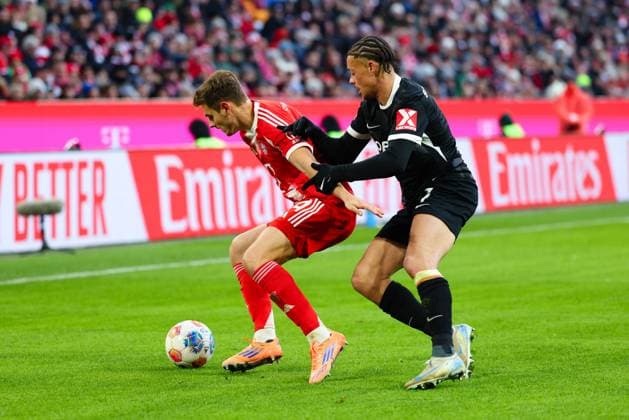 Josip Stanisic 44, FC Bayern München and Derry Scherhant 7, SC Freiburg at the match between FC Bayern München v SC Freiburg, Football, Men, Bundesliga, 2025 2026, Matchday 11 on 22 11 2025 in Munich, Allianz Arena DFL and DFB regulations prohibit any use of photographs as image sequences and or quasi video Bayern Germany