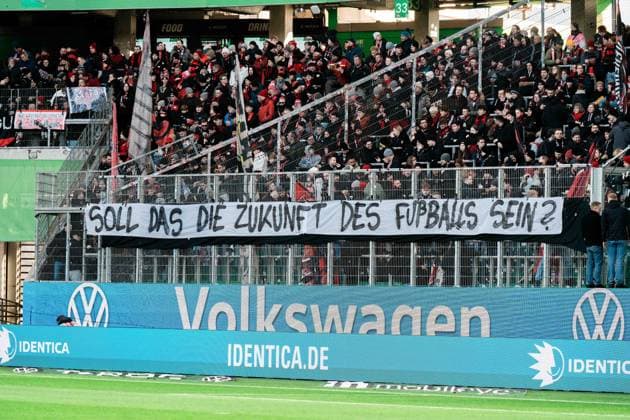 Germany, Football, 1 Bundesliga 2025 26, Matchday 11 VfL Wolfsburg vs Bayer Leverkusen Volkswagen Arena Wolfsburg Protest banner guest block Bayer Leverkusen Is this the future of soccer? Copyright: xJamesxZabelx